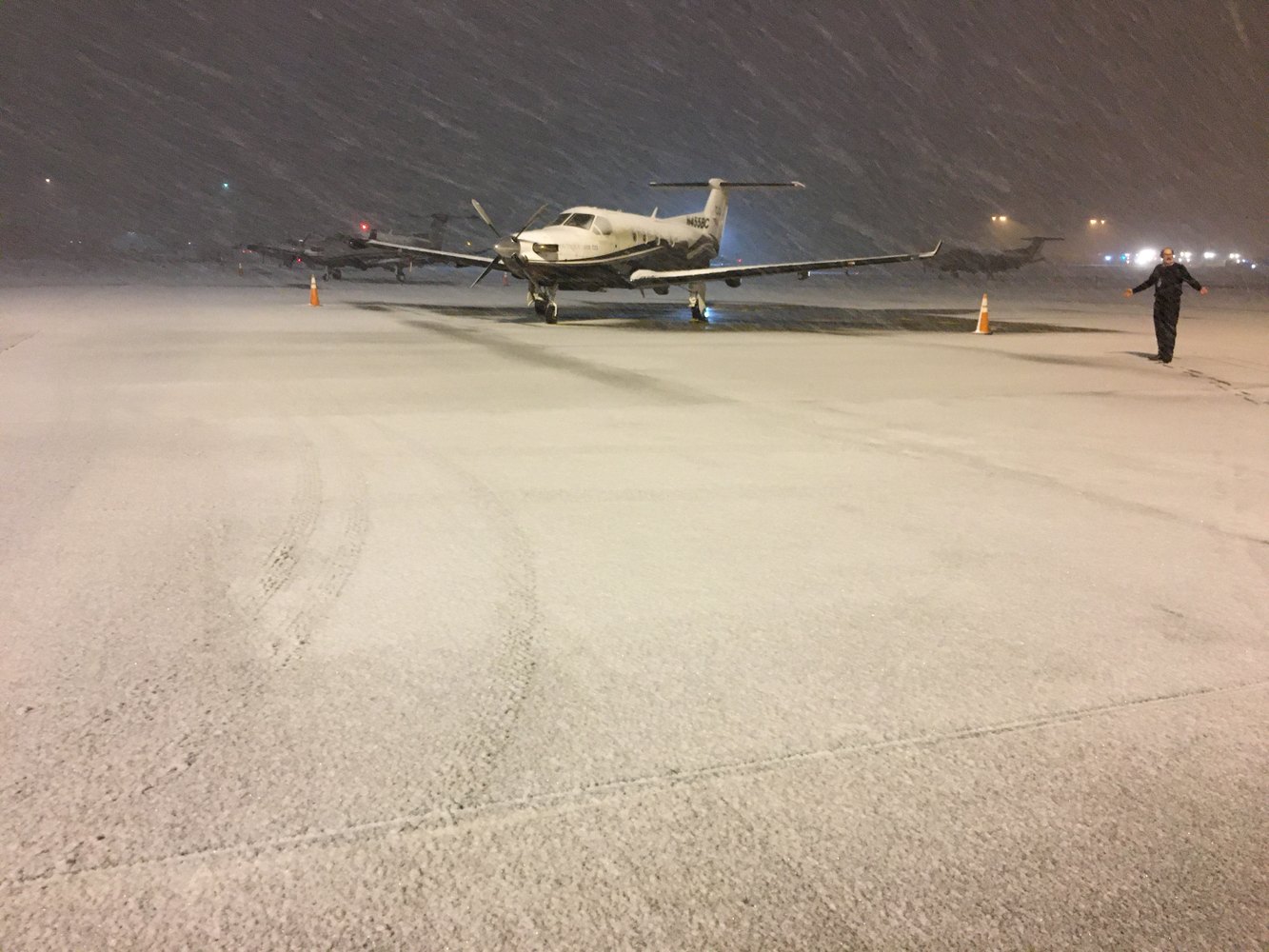Nighttime snowstorm on the ramp with PC-12 and pilot